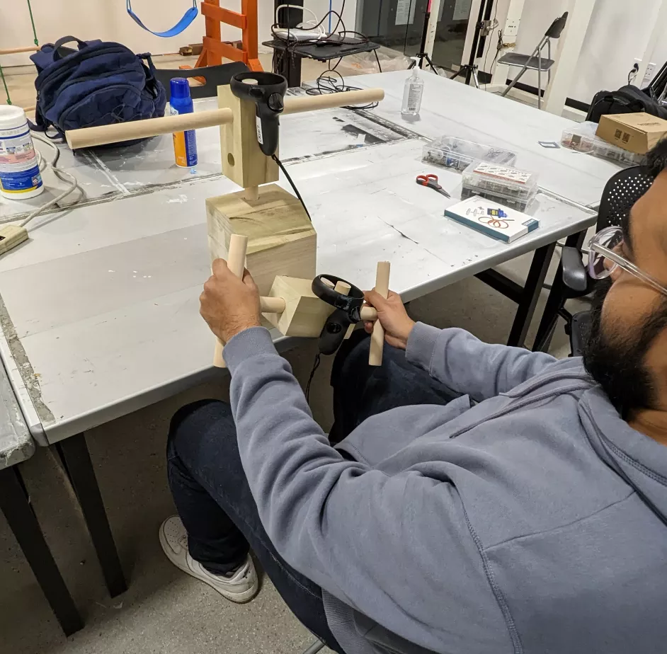 A image showing a person test-driving the finalized prototype with wood